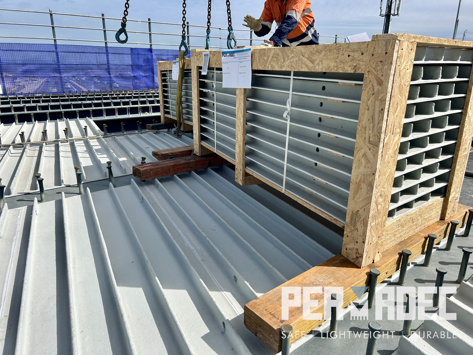 Permadec GRP formwork panels delivered in crates onto bridge deck, showing glass reinforced polymer permanent formwork ready for installation on major infrastructure project.