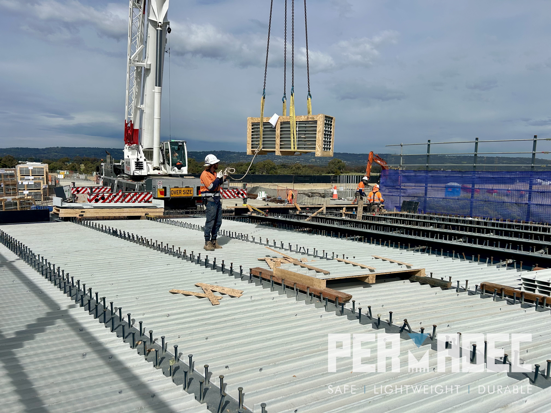 Crane lifting GRP formwork panels for installation on bridge deck at Majors Road, South Australia – Permadec glass reinforced polymer permanent formwork system.