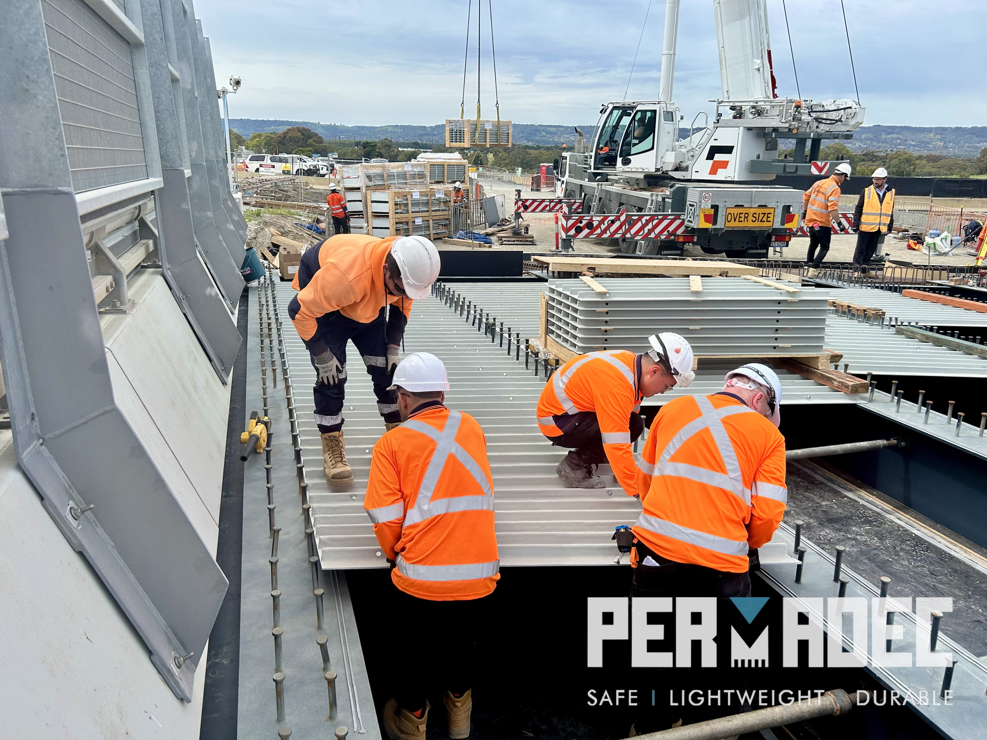 Construction crew installing Permadec GRP (Glass Reinforced Polymer) formwork panels at Majors Road, South Australia, as part of a permanent bridge formwork system.