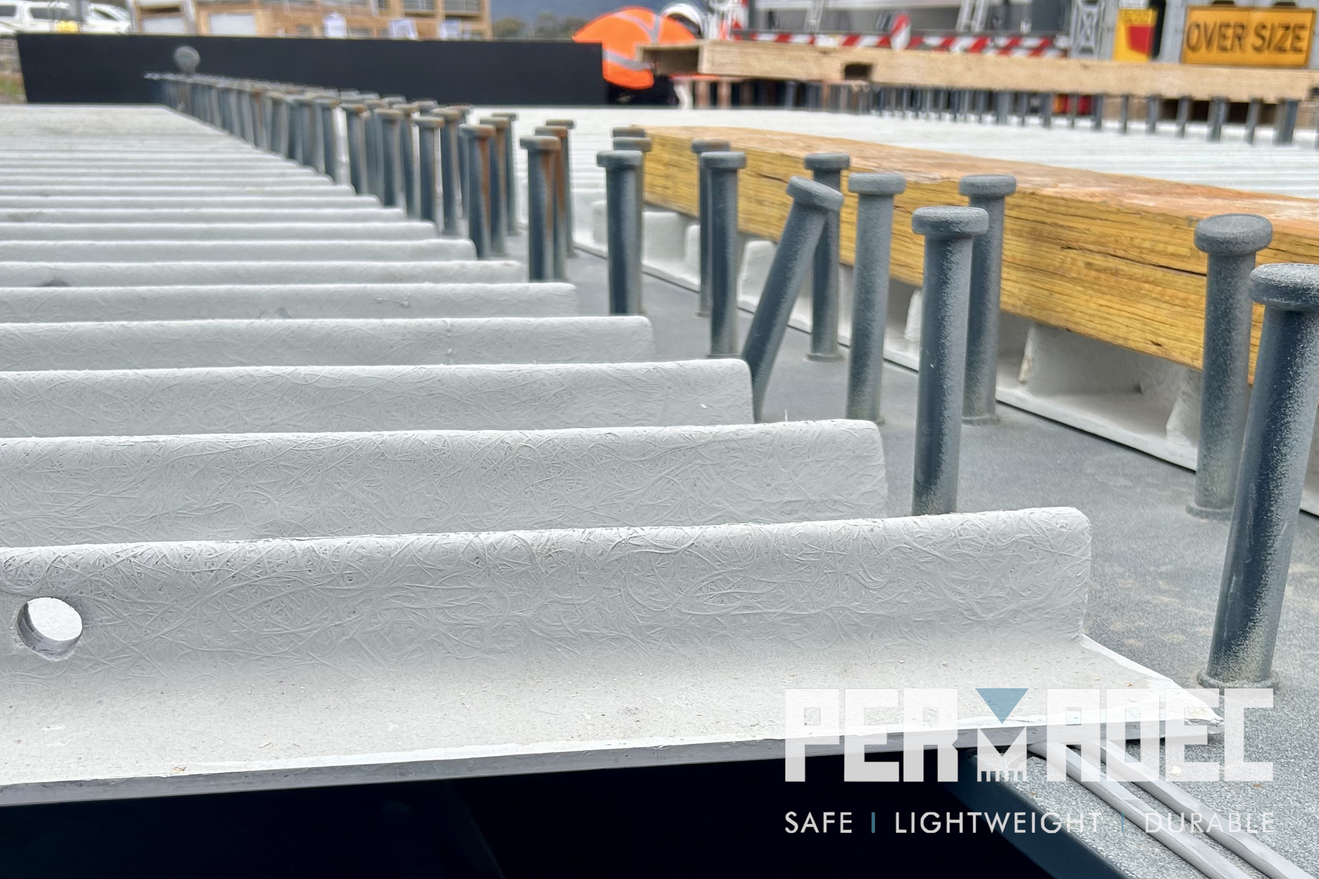 Close-up view of a Permadec panel installed on a steel beam, showing shear studs and textured surface for composite slab construction at Majors Road