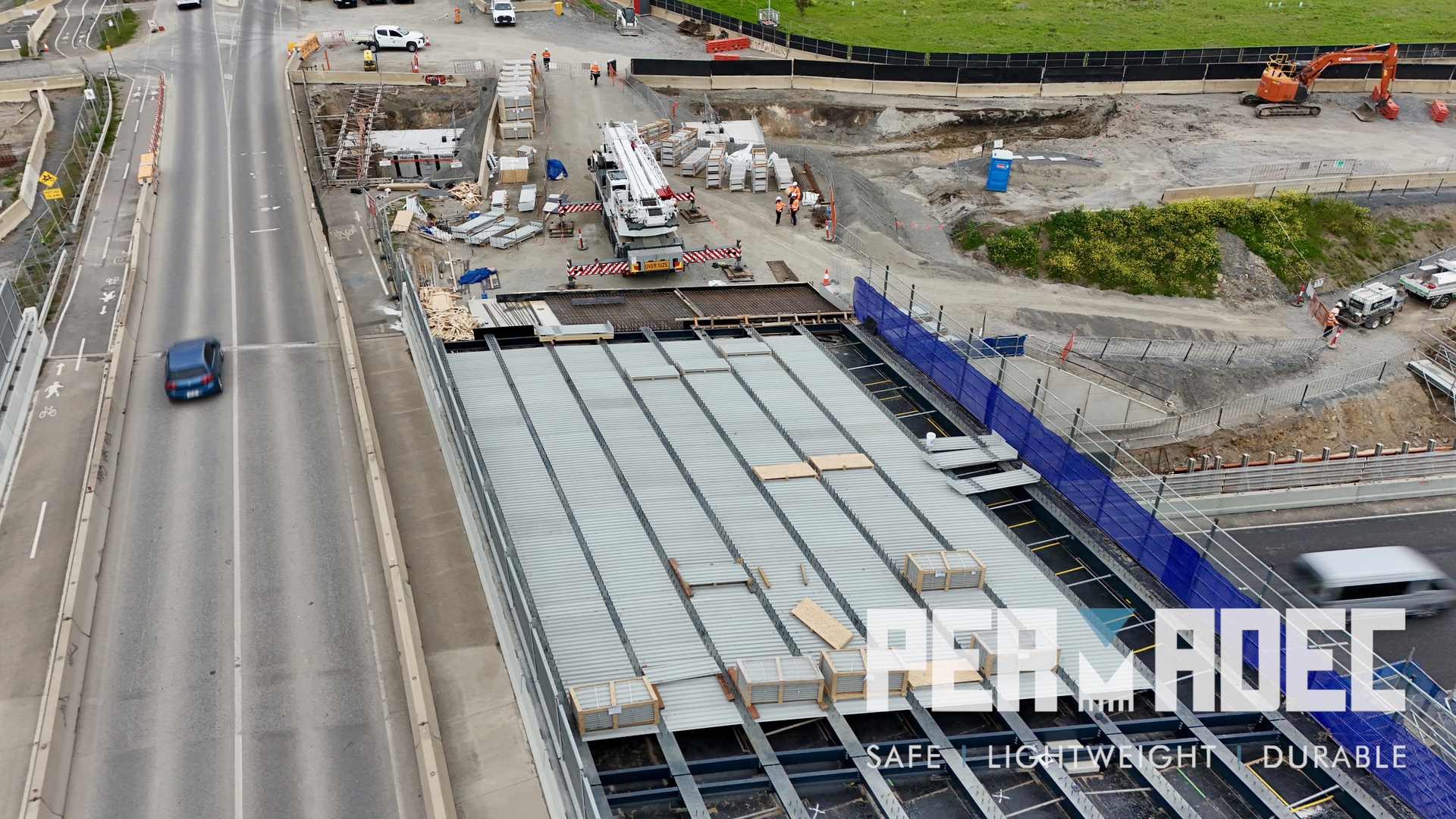 Aerial view of GRP formwork installation by Permadec over live highway at Majors Road Interchange. Glass reinforced polymer panels used for permanent bridge formwork.